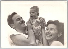 Vtg B&W Snapshot Happy Family Smiling Man Woman Holding Baby In Romper 1950s