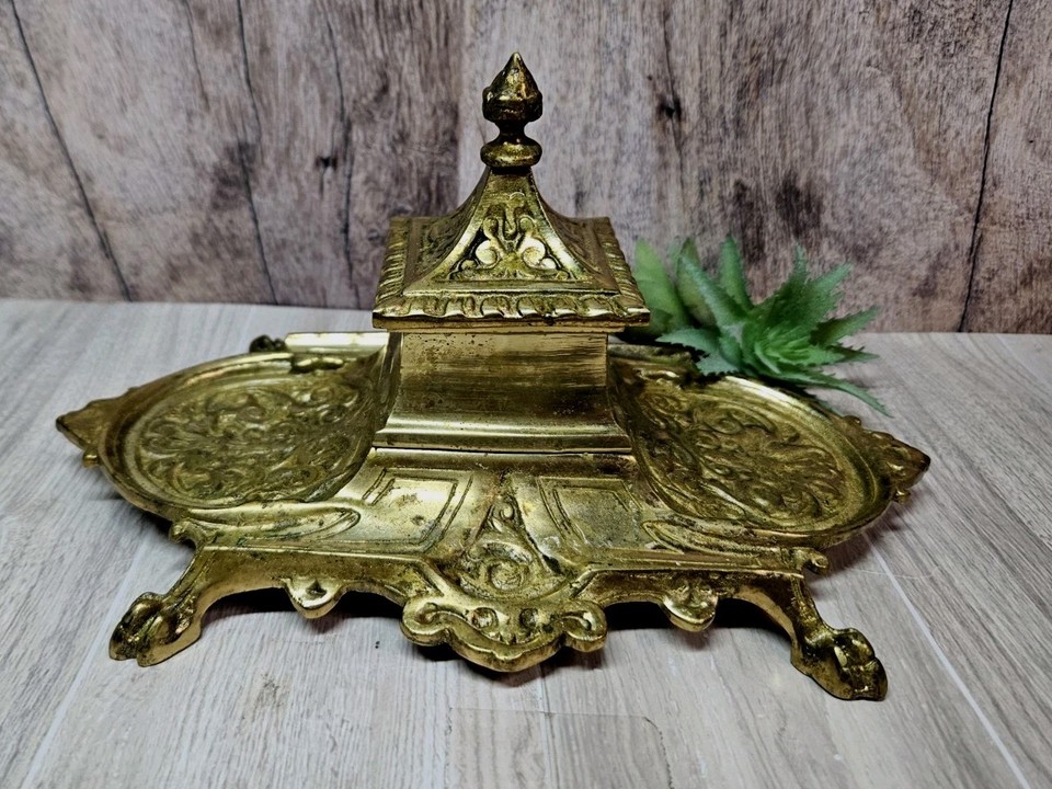 An ornate Victorian double inkwell set with hinged lids — the kind of desk accessory that makes your WFH setup look like you're signing the Treaty of Versailles.