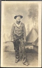 STUDIO REAL PHOTO RPPC~MAN COWBOY COSTUME w LEATHER CHAPS~INDIAN TIPIS BACKDROP