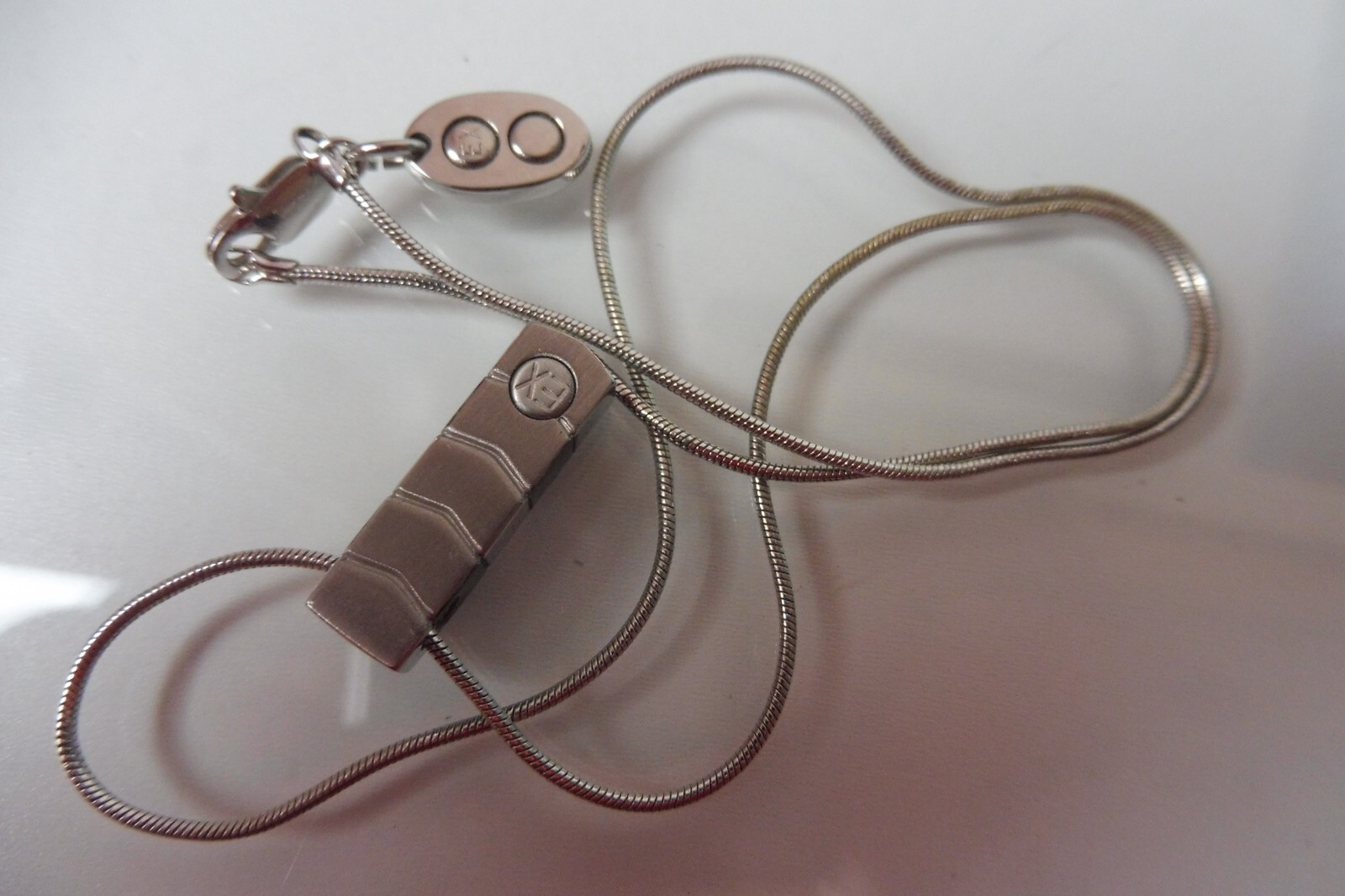 Elegant EX Embossed Pendant Necklace with Stylish Chain Design