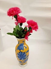 A yellow flower vase for home decor hanging on the walls of the house