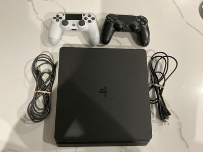 PS4 Slim 1 Tb, With 2 Controllers, Charging Cord, Power Cord, And Game Included.
