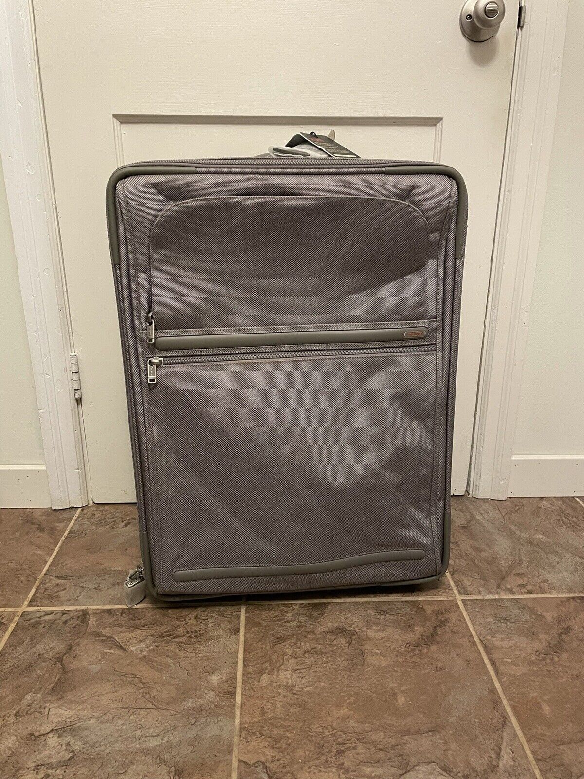 TUMI  Wheeled Expandable Short Trip Suitcase with defects  Silver tone