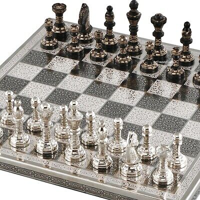 At Auction: A large ornate chess set with sterling silver board. Board  measures 46x46x8cm