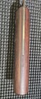 Vintage WESTERN fish fillet knife with red wood grain, gold center line, and flat rectangular sheath on black background.