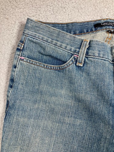 Blue stretch light wash Karen Kane women’s jeans with front pockets, belt loops, and pink rim detail on waistband.