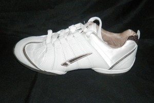 white shoes with gold stripes