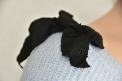 black sweater with bow on shoulder