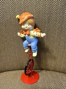 Enesco Country Cousins Katie riding a unicycle