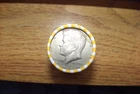 Kennedy half dollar roll with a 40% silver 1969-D  half on end in vV- good cond.