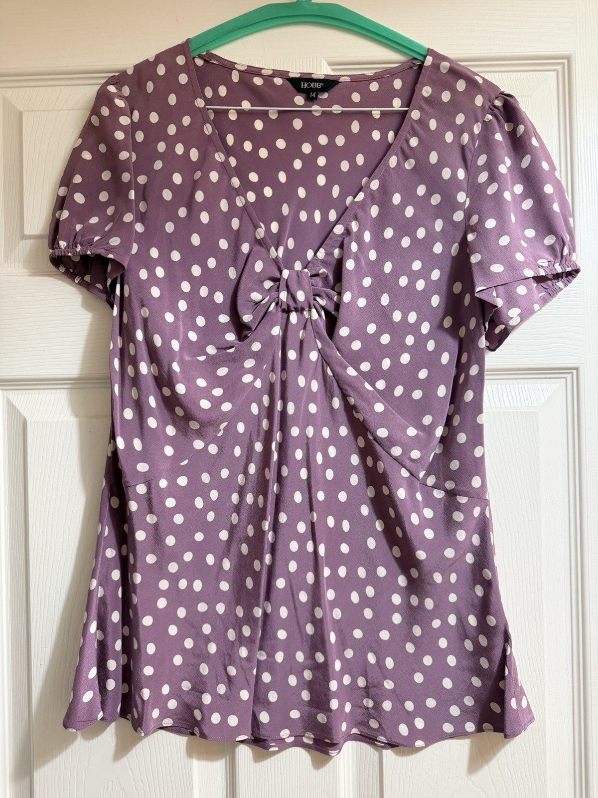 Purple silk blouse with white polka dot print.