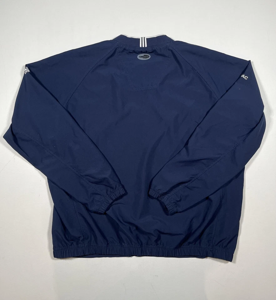 Chaqueta cortavientos Adidas para hombre grande azul a prueba de clima pulóver Nissan NMAC Golf Foto 2 de 4