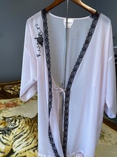Sheer light pink robe featuring black floral lace trim
