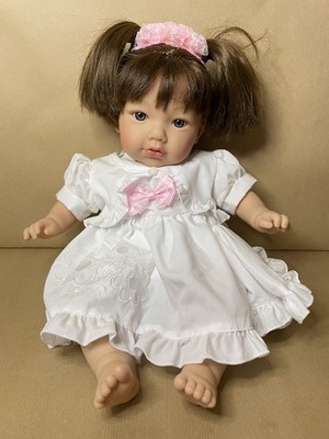 MARINA & PAU Baby doll in white dress. Around 17 inches high