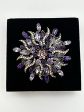 vintage-style floral starburst brooch crafted with purple and lilac rhinestones