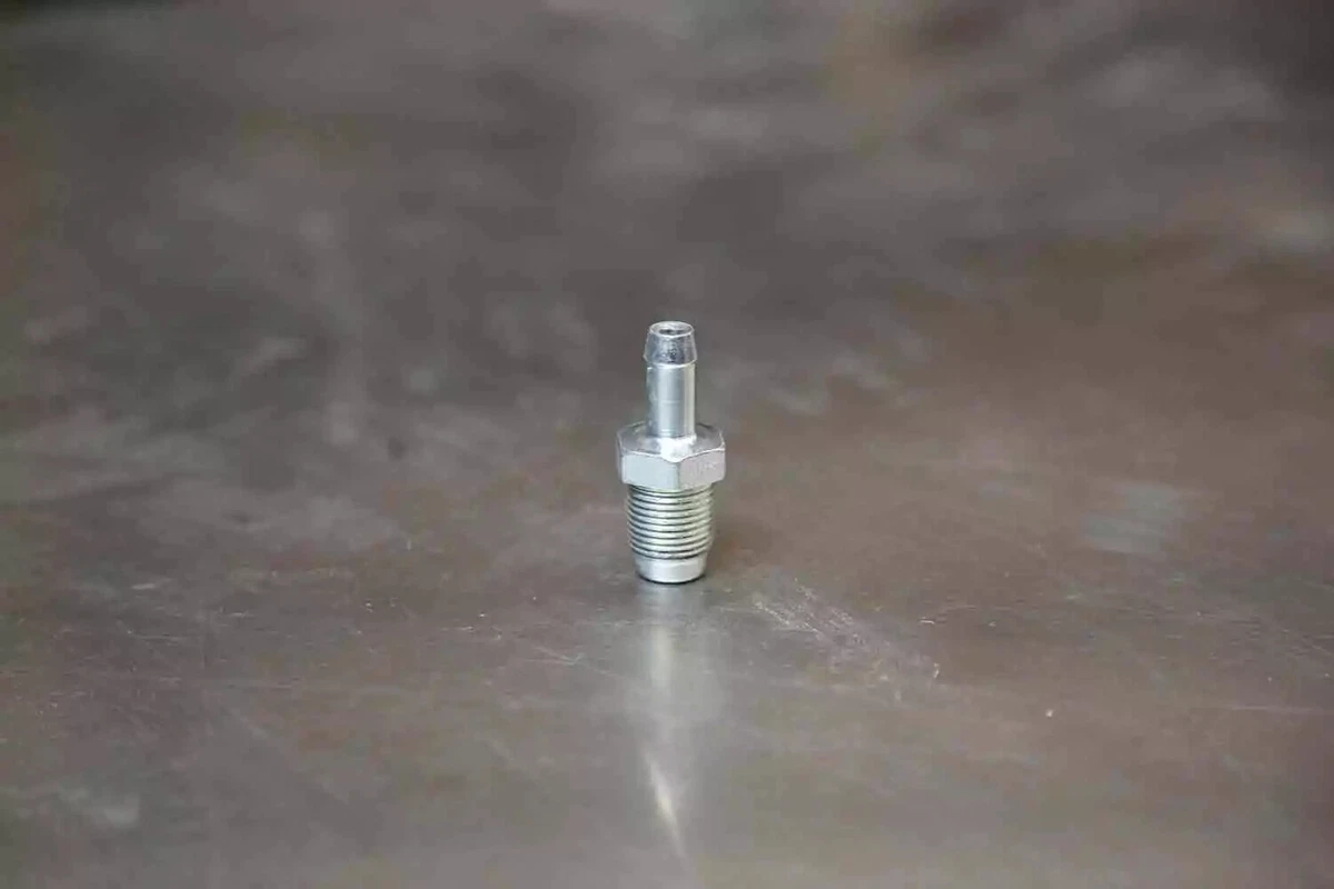 A clean PCV valve sitting on a work surface.