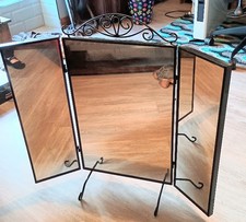 A beautiful, versatile mirror with elegant wrought iron detailing.
