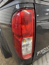 Used Left Tail Light Assembly fits: 2012 Nissan Frontier quarter panel mounted L