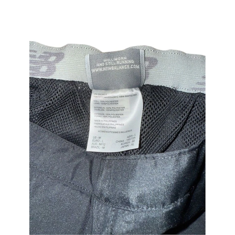 Pantalones cortavientos New Balance negros para mujer M informales pierna recta atletismo Foto 3 de 4