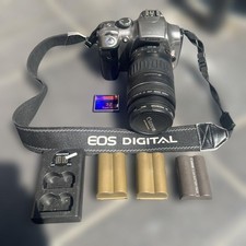 Used Canon EOS Kiss Digital Camera, includes 3 batteries, charger, and 32GB CF