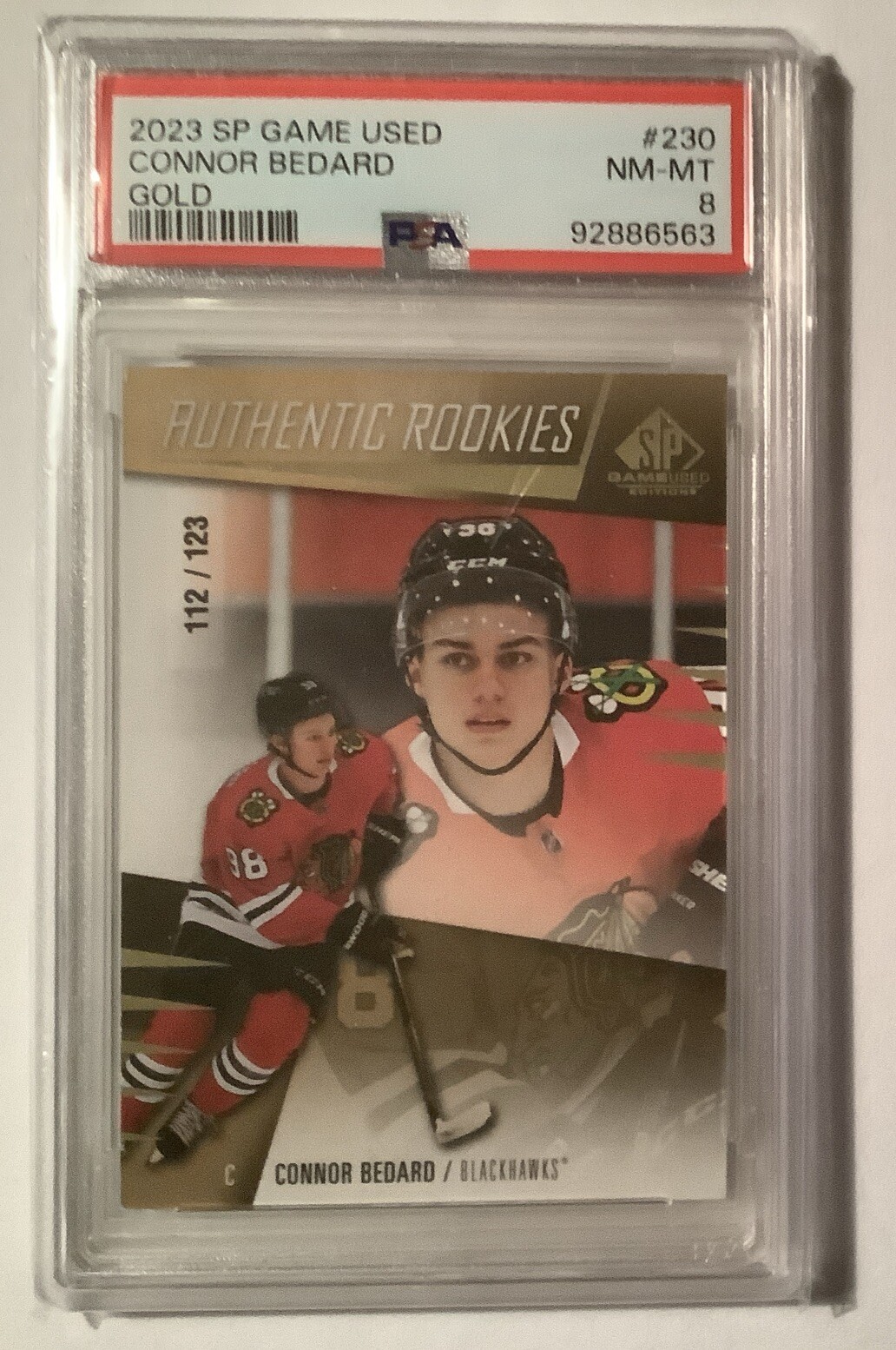 2023-24 Connor Bedard SP Game Used Authentic Rookies #230 Gold 112/123 PSA 8 view 1