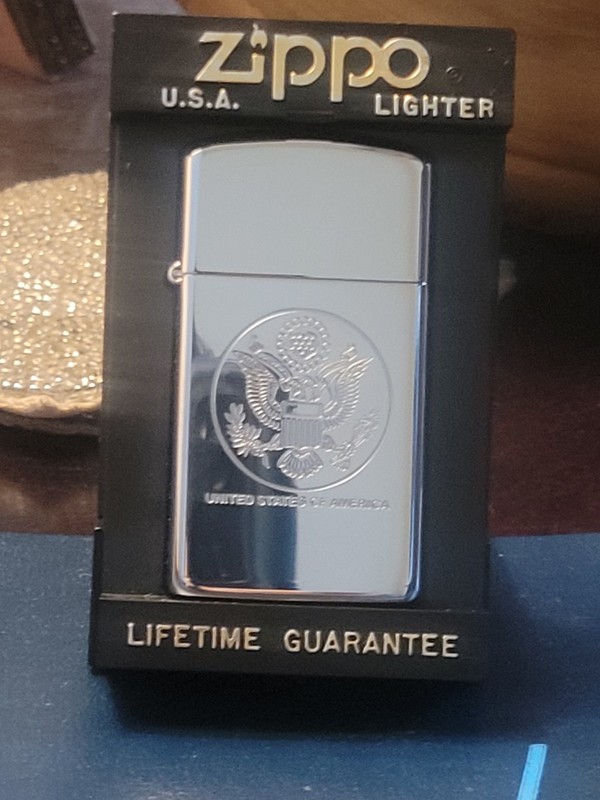 Zippo lighter with United States of America seal; June 1990, in box