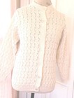 White knit women's long sleeve sweater with scalloped pattern, button front, and two front pockets made in the USA.