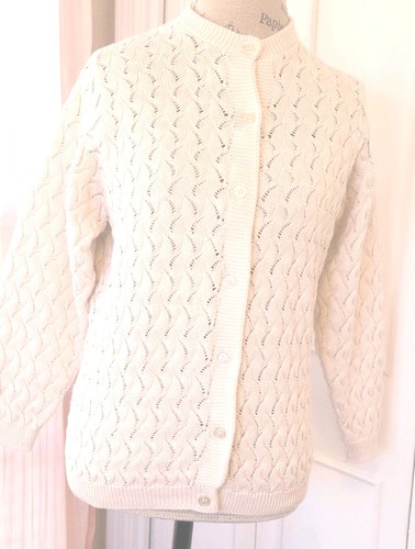White knit women's long sleeve sweater with scalloped pattern, button front, and two front pockets made in the USA.