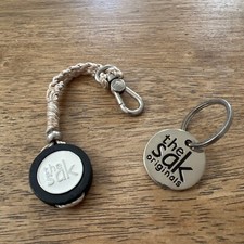 THE SAK KEYCHAIN SILVER TONE WHITE MEDALLION KEY FOB BAG CHARM HANGTAG 2 PCS.