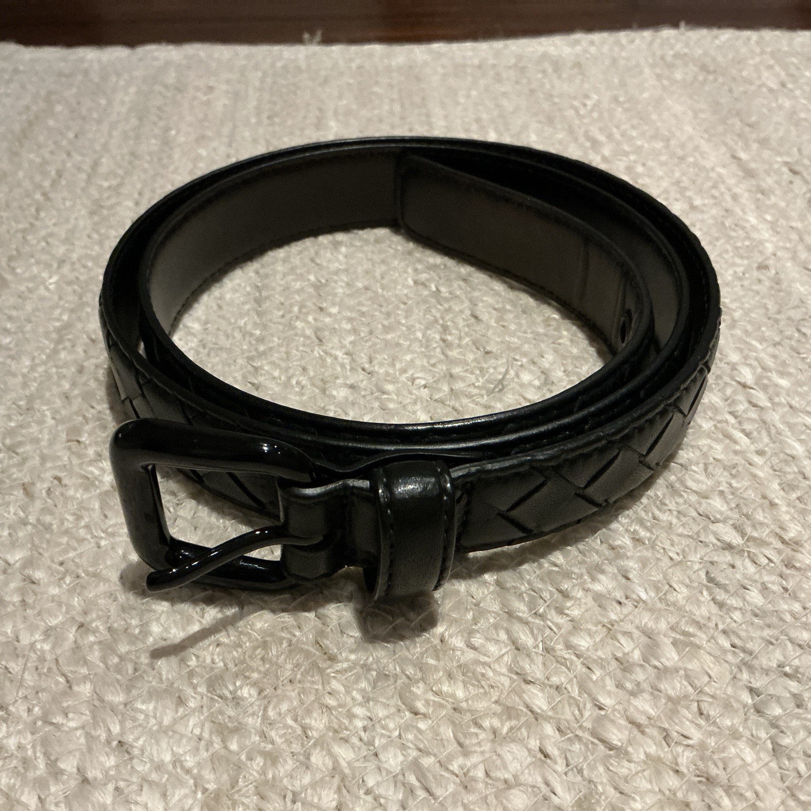 A black Bottega Veneta belt in woven Intrecciato nappa leather.