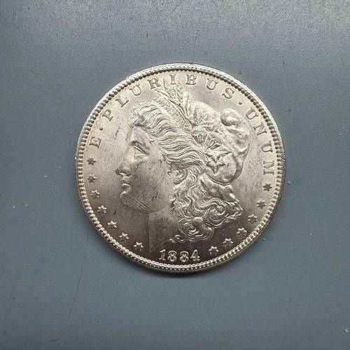 1884-CC MORGAN SILVER DOLLAR. UNCIRCULATED. HIGH GRADE.