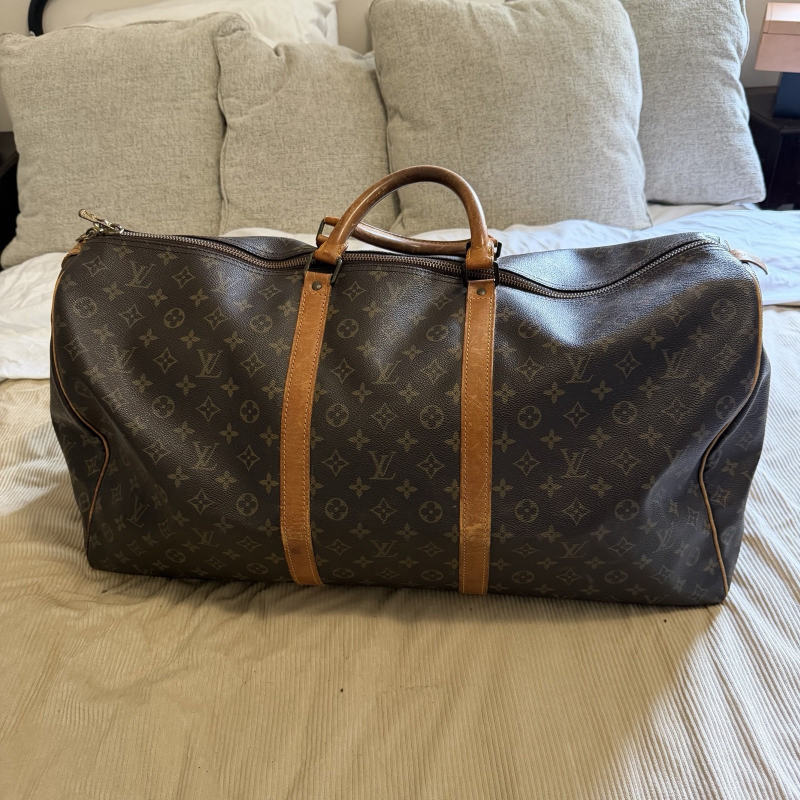 Louis Vuitton Keepall 55 travel bag Monocoated canvas leather trim.