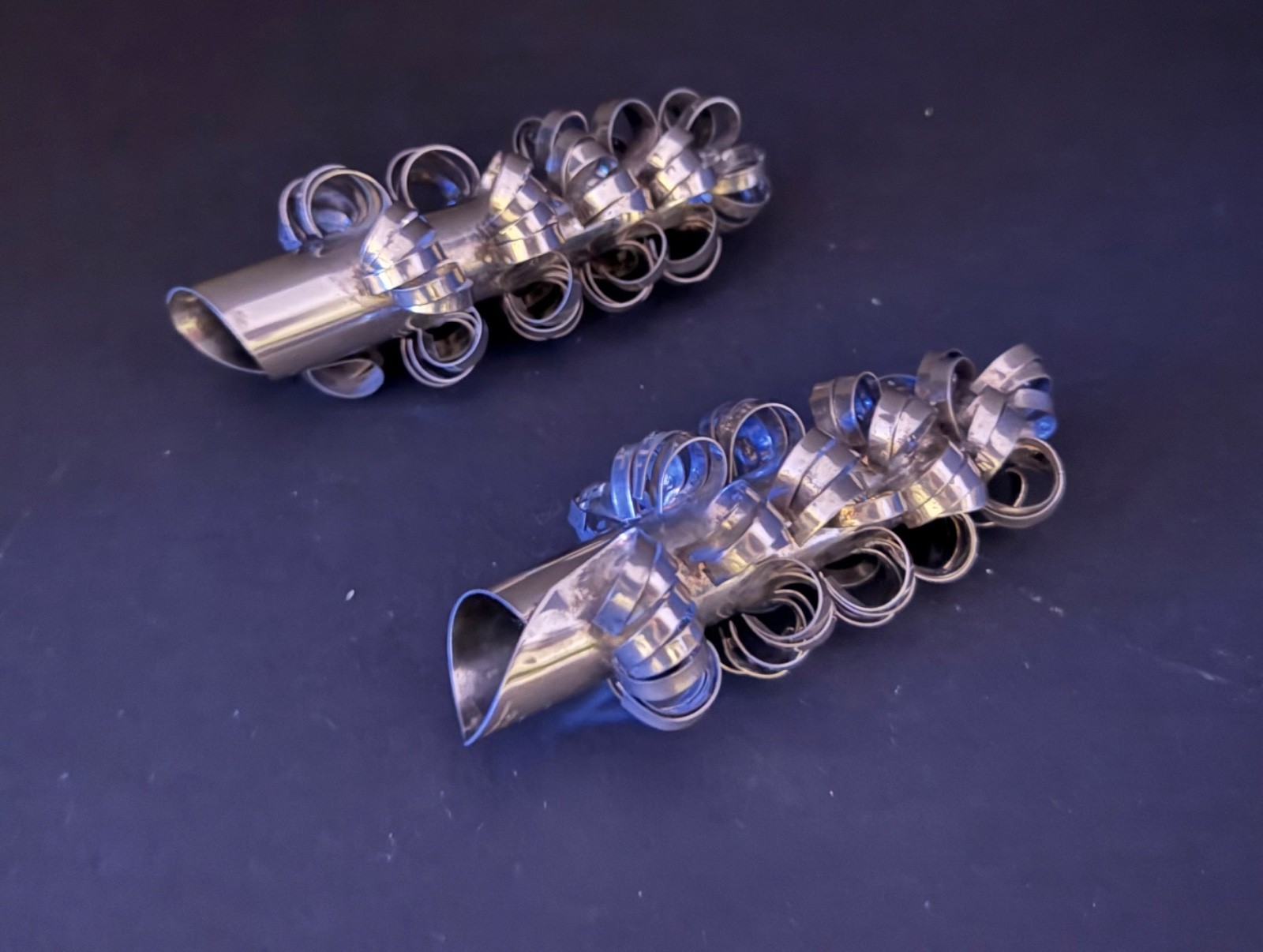 Pair of eFeCe Lisboa curled metal ribbon candle covers