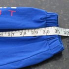 Blue fabric Vtg 90s Polo Sport Ralph Lauren sleeve with white measurement tape in inches, sizes A to XL.
