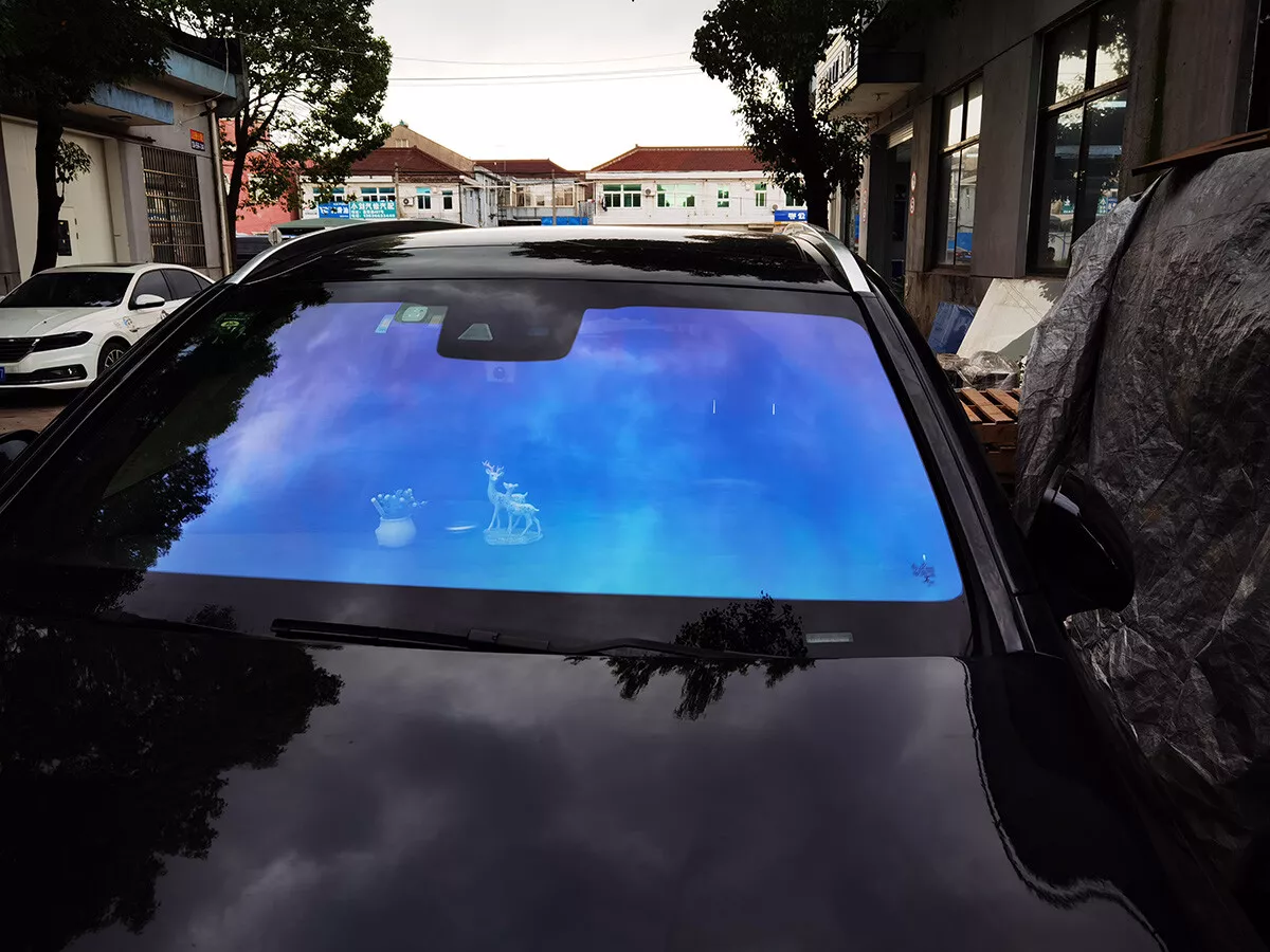 Tinted dark glass foil removal from car window. Stock Photo by