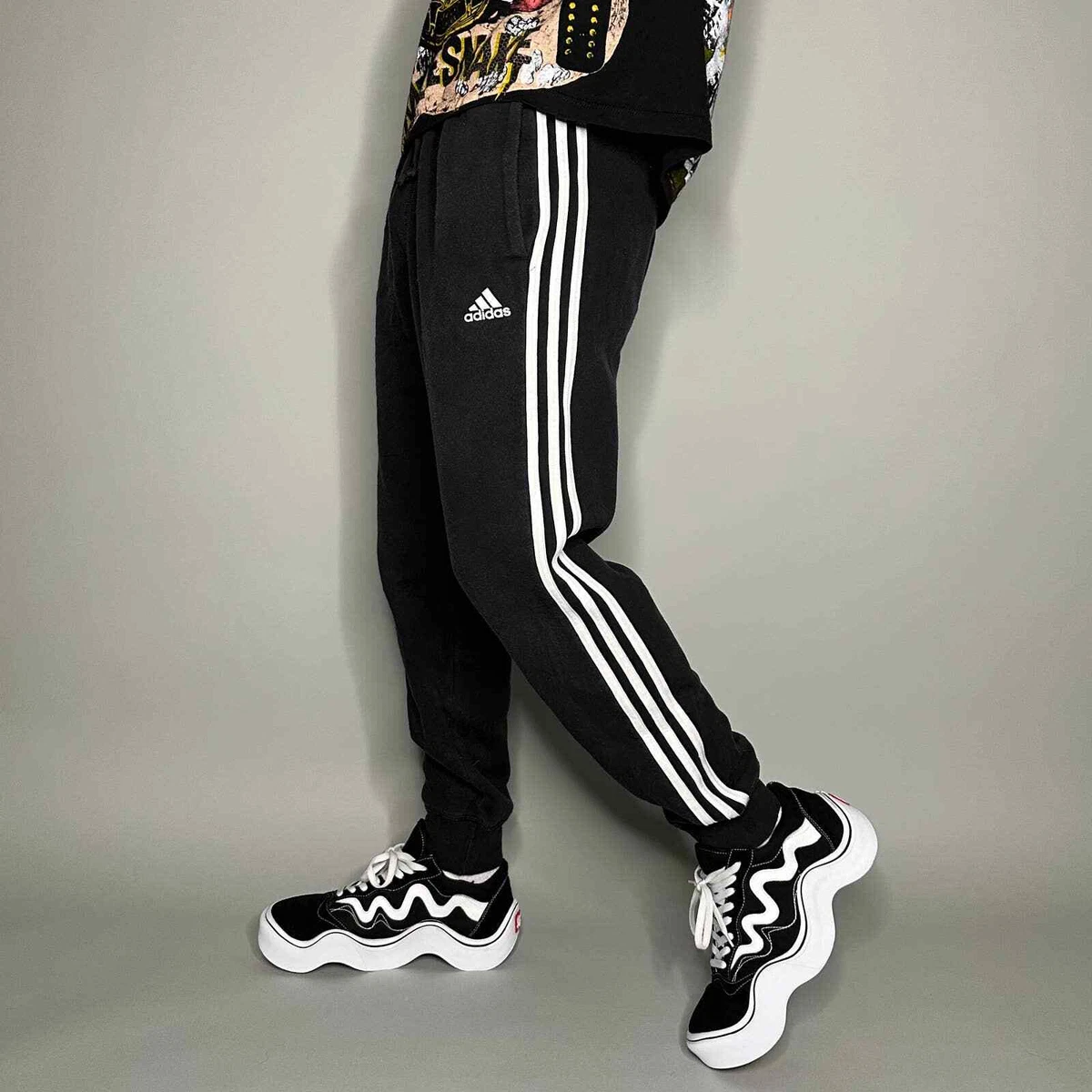 White adidas joggers with 2025 black stripes