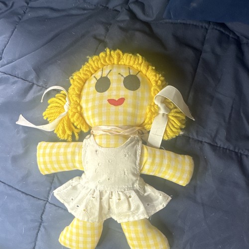 This vintage handmade cloth doll features a distinctive yellow gingham plaid fab