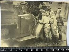 beautiful young guys soldiers in uniform near the car, closeness, old photo