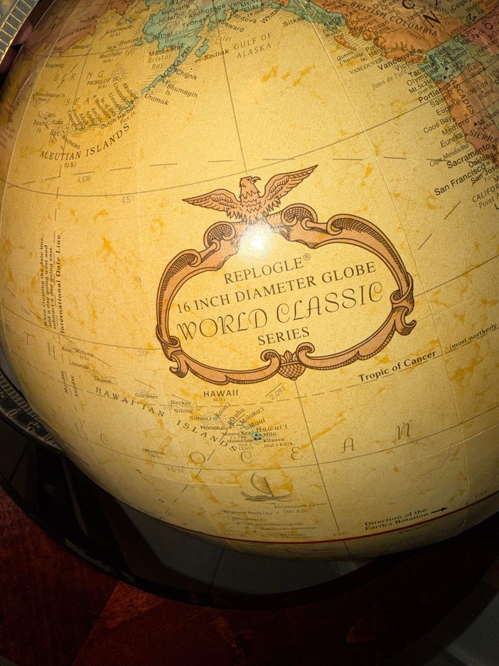 A 16" Replogle Monterey Classic globe on a solid wood stand — substantial, handsome, and the kind of thing that anchors a home office like a boss.