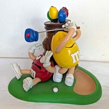 M&M  Red Yellow Mulligan Ville Golf with Brown Bag and Blue Hat Candy Dispenser