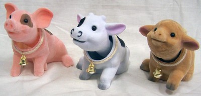 cow with toy car on head