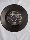 THE BEATLES "SHE LOVES YOU" 1963 7" VINYL SINGLE IN A PLAIN SLEEVE