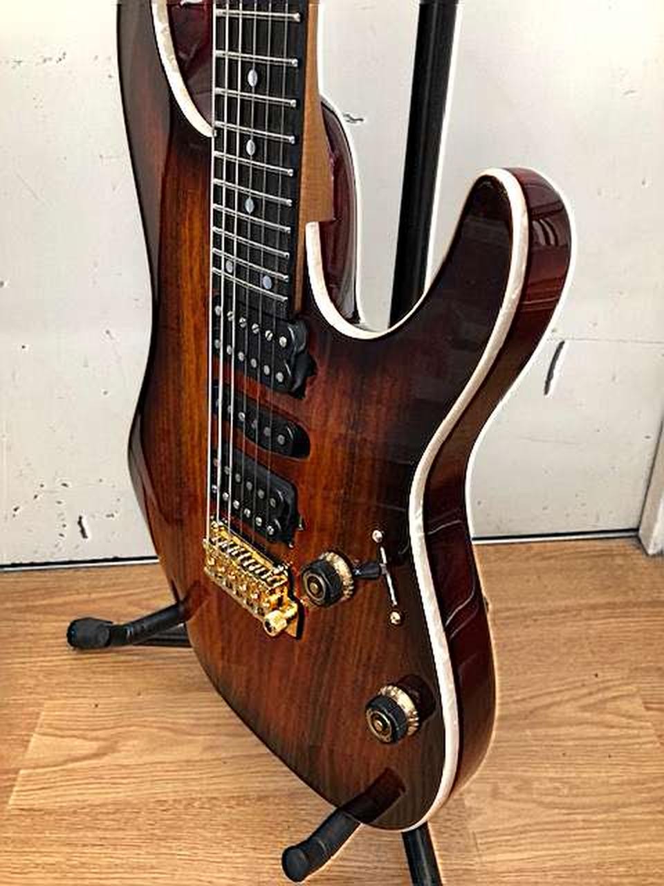 Ibanez AZ47P2K Dragoneyeburst used electric guitar with gold hardware, black pickguard, and seven strings on fretboard.