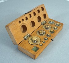 11 old weights apothecary weights merchant weights in wooden box 1950s.