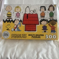 PEANUTS 300pc Puzzle Set Incl. 9 Individual Multi-Shaped Puzzles Poster