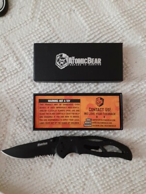 The Atomic Bear Prepare to Survive all black pocket knife with combo edge blade