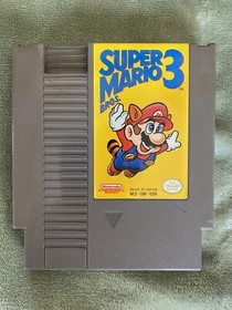 NES with Mario/Duck Hunt/track & field, Super Mario 2, and Super Mario 3 carts