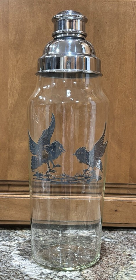 Art Deco cocktail shaker with a silver overlay of chicks — absurdly specific, visually stunning, and a true one-of-a-kind barware statement piece.