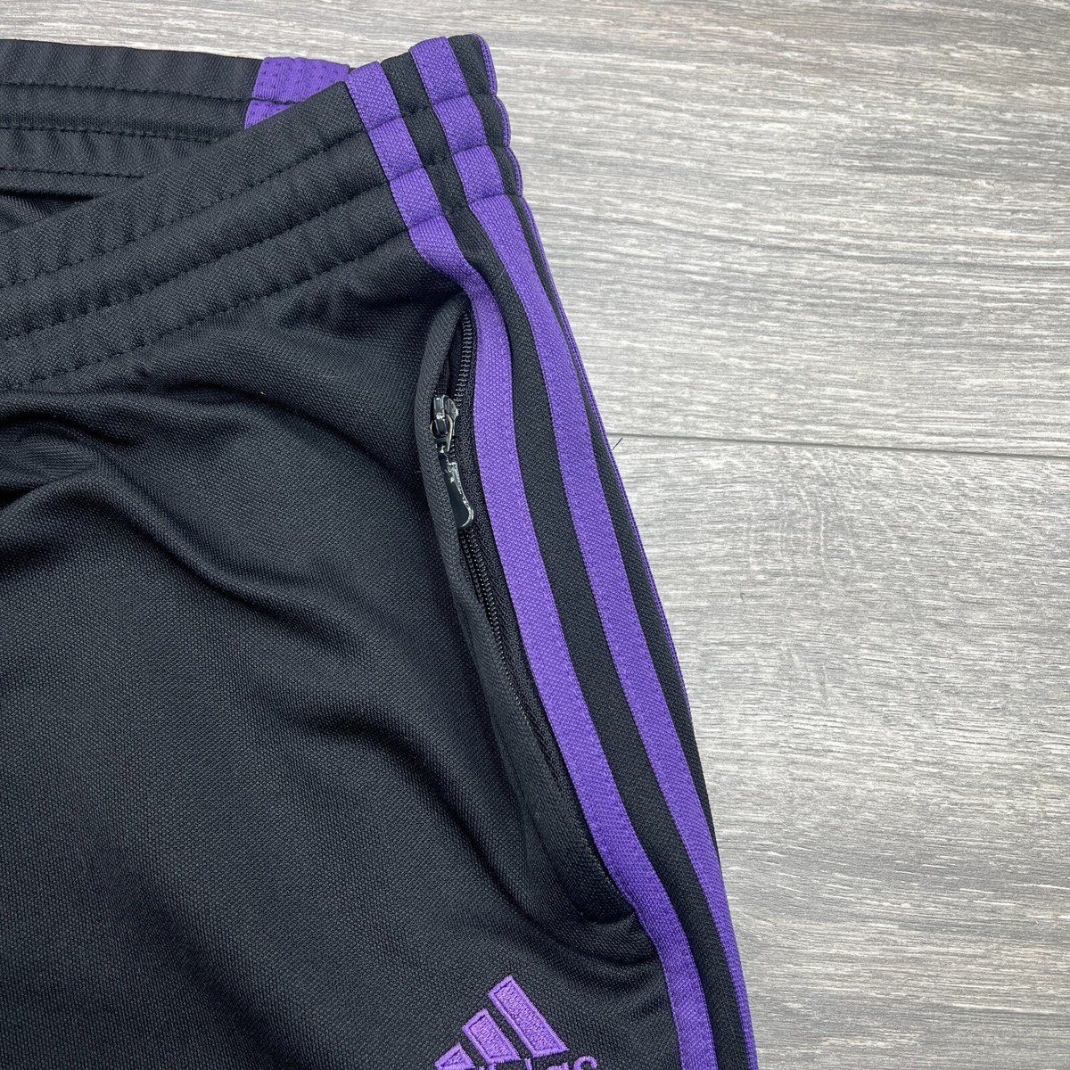 black adidas pants with purple stripes