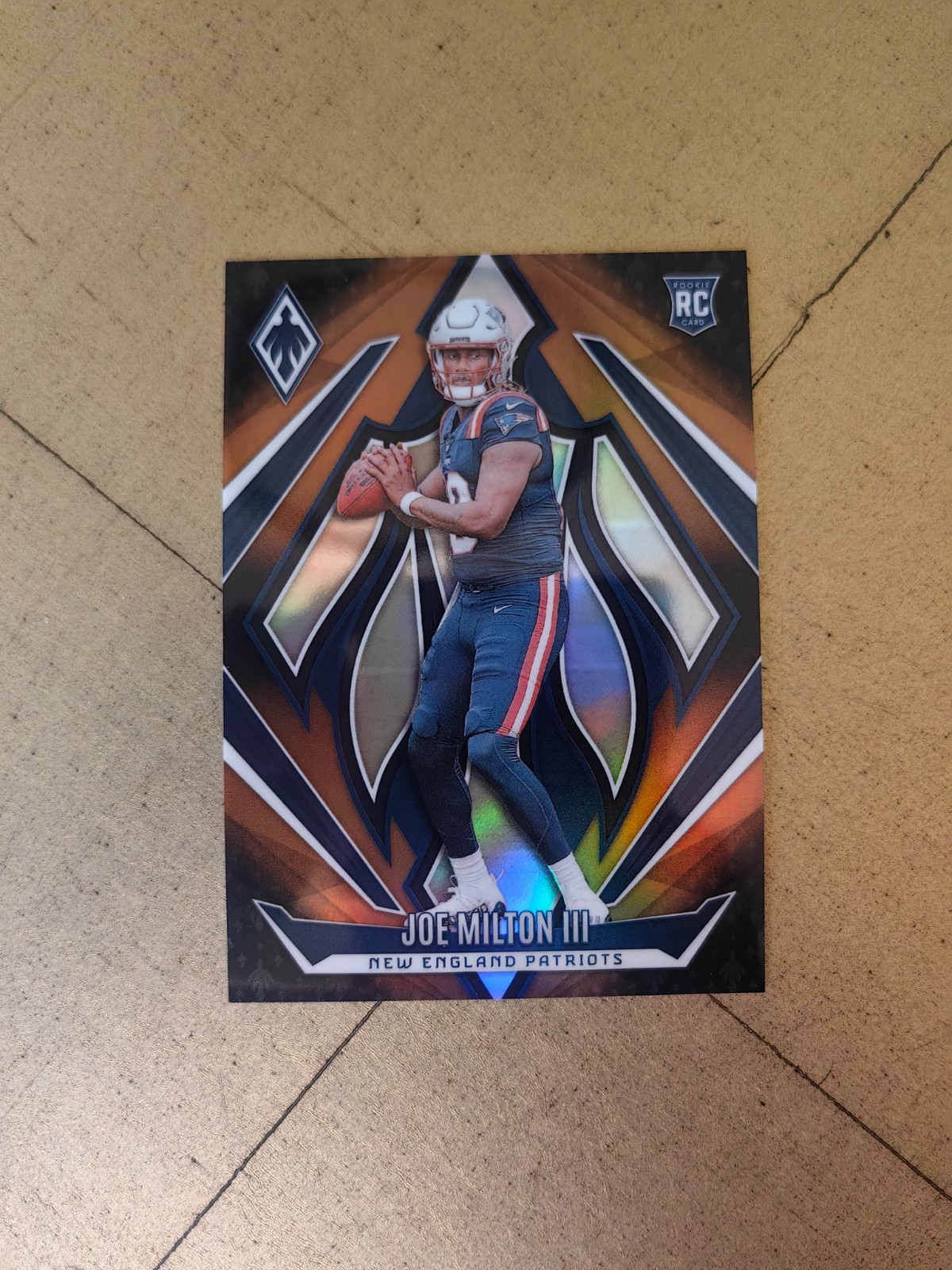 2024 Panini Phoenix Football #205 Joe Milton III, Patriots RC Bronze Fade – /125